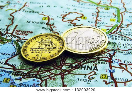 2 Coins On A Map Of Greece, One Euro And One Drahma