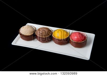 Four different ice cream sorts on a black background