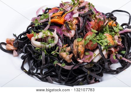 Black Spaghetti With Seafood And Vegetables On White Plate