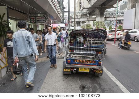 BANGKOK THAILAND - APR 30 : tuktuk parking near Seven - Eleven store in siam square on april 30 2016 thailand. tuktuk is name of three wheeled taxi car in thailand