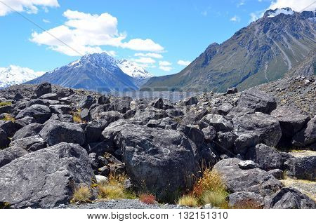 Scree slope at the base of a snow covered rocky mountain range