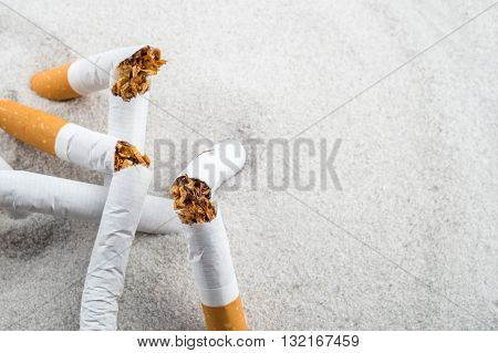 Quit Smoking - Broken Unsmoked Cigarettes In Sand With Copyspace