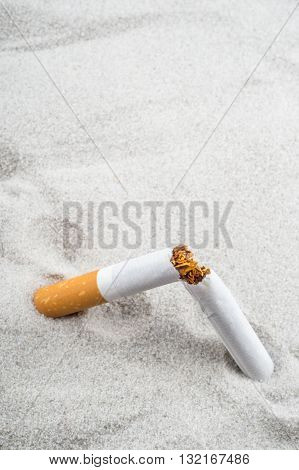 Quit Smoking - Broken Unsmoked Cigarette In Sand With Copyspace