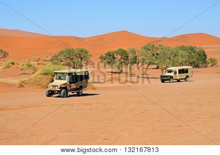 SOSSUSVLEI NAMIBIA - JAN 29 2016: Safari cars in the Namib-Naukluft National Park. The most visited place in Namibia