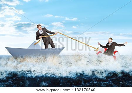 Businessman in paperboat save scared man in lifebuoy