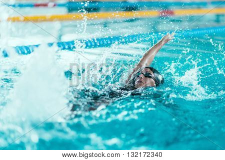 back stroke swimmer in the pool, horizontal image,