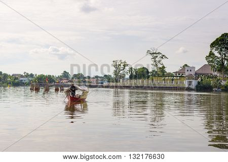 Kuching Malaysia - August 9 2014: People crossing the Sarawak River on boat from the Waterfront Promenade in Kuching Borneo Malaysia.