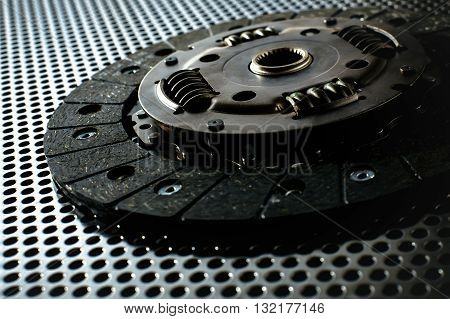 Car clutch on a metal surface. Photo from the classical vignetting effect it and a small depth of field