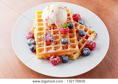 Belgian waffles with ice cream and fresh berries