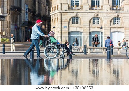 People Visiting A Mirror Fountain In Bordeaux, France