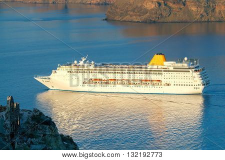 Beautiful landscape with sea and passenger ship near island Nea Kameni. Santorini Greece.