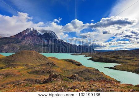 Emerald waters of Lake Pehoe at rocks Los Kuernos. National Park Torres del Paine, Patagonia, Chile