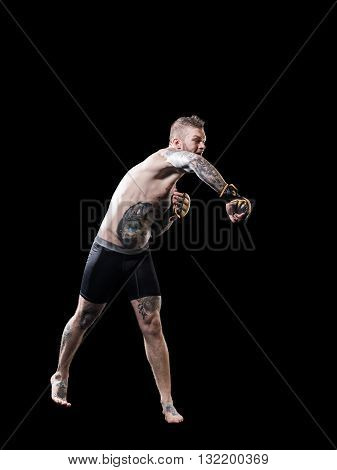 Young MMA fighter training on black background