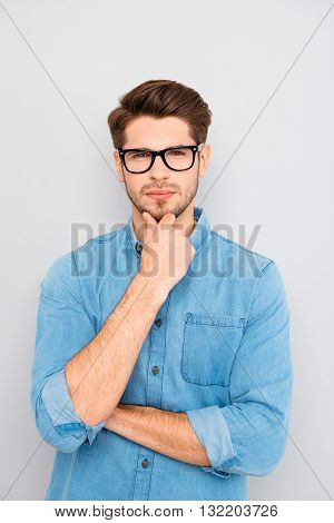 Portrait Of Handsome Minded Young Man In Glasses