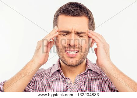 Attractive man suffering of headache 
on a white background
