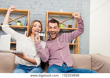 Cheerful Family Making Internet Shopping With Laptop And Bank Card
