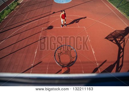 Young male basketball player taking a free throw.