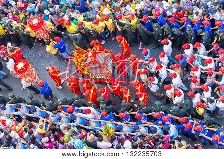 Binh Duong, Vietnam - February 22nd, 2016: Festival goddess Chinese Lantern red procession carrying censer bless organizing committee business protected around march on road in Binh Duong, Vietnam