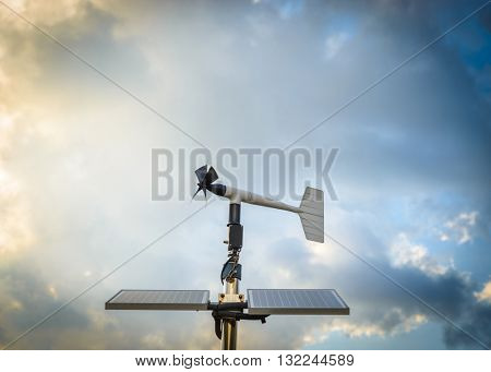 A solar powered anenometer against a dramatic stormy sky