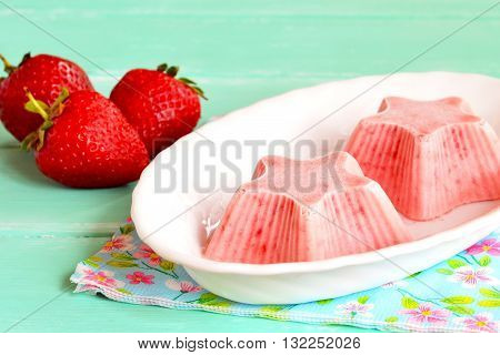 Strawberry ice cream cooked at home. Strawberries mixed with yogurt and sugar and frozen in a freezer. Fresh strawberry sorbet. Healthy light berry dessert. Ice cream shaped star