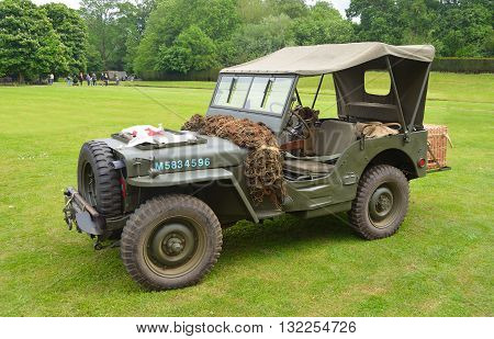 Silsoe, Bedfordshire, England - May 30, 2016: World War 2 Jeep with Red Cross Banner parked on grass..