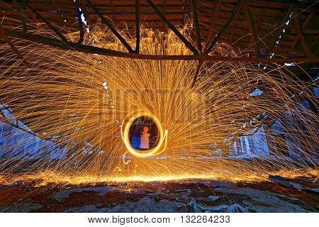 Burning Steel Wool spinning. Showers of glowing sparks from spinning steel wool in ruins