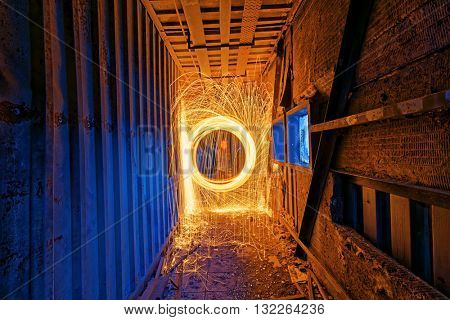 Burning Steel Wool spinning. Showers of glowing sparks from spinning steel wool in ruins