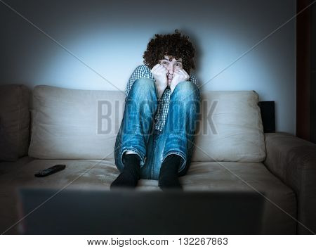 Young Scared Man Is Watching Horror Or Thriller On Tv.
