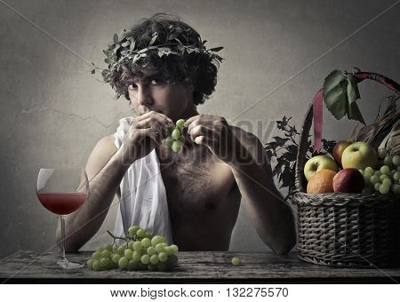 Bacchus holding a bunch of grapes