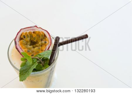 Refreshing with a glass of passion fruit smoothie on white background.