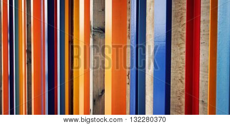 Colorful fence. Repeated wooden blocks. Aged photo. Abstract geometric background. Vintage filter photo. Urban design.