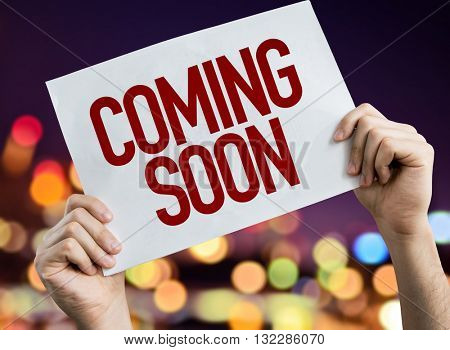 Coming Soon placard with night lights on background