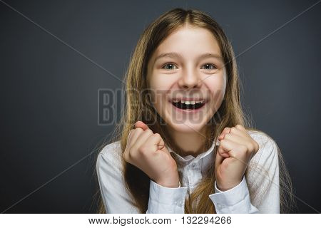 Closeup Portrait of happy girl going surprise isolated on gray background.