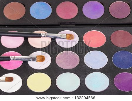 Eyeshadow palette cosmetic brushes and makeup. Background. View from above.