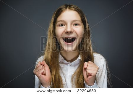 Closeup Portrait of happy girl going surprise isolated on gray background.