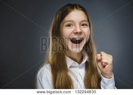 Closeup Portrait of happy girl going surprise isolated on gray background.