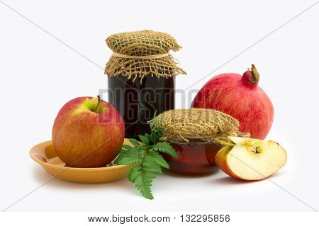Jar of honey apple and pomegranate on white background