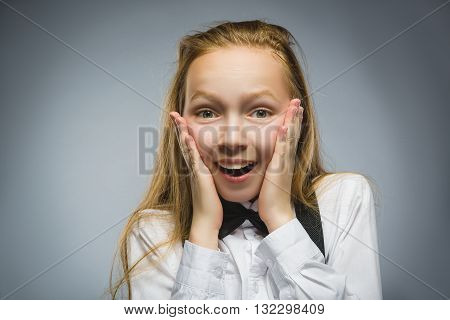 Closeup Portrait of happy girl going surprise isolated on gray background.