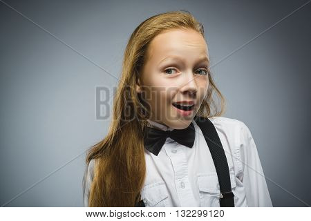 Closeup Portrait of happy girl going surprise isolated on gray background.