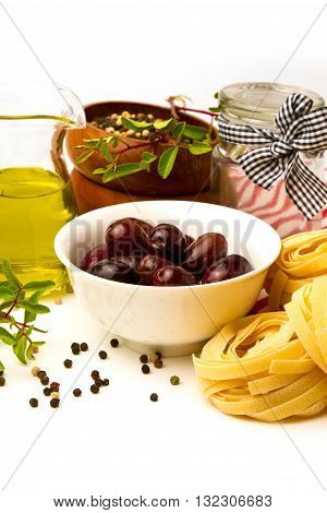 Italian pasta with olives olive oil and tomato on white background