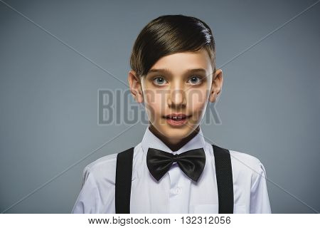 Closeup Portrait of happy boy going surprise isolated on gray background.