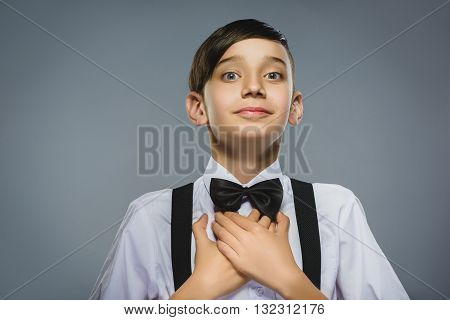 Closeup Portrait of happy boy going surprise isolated on gray background.