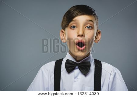 Closeup Portrait of happy boy going surprise isolated on gray background.