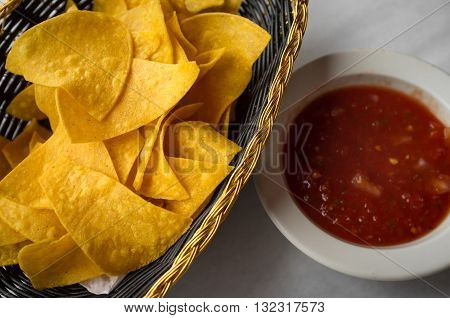 Mexican crispy tortilla chips with spicy red tomato salsa