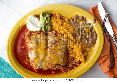 Authentic Mexican chimichanga burrito with sour cream jalapeno and cilantro