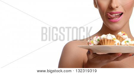 Beauty fashion model girl taking colorful cakes