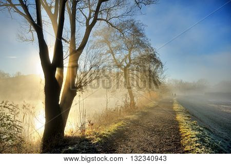 Sunrise  on Adda river during winter with fog on the water