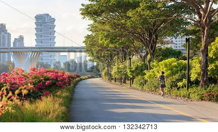 Jogger at Marina Bay East park at sunset