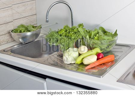 Fresh vegetables and kitchen ware in a modern kitchen indoor closeup shot