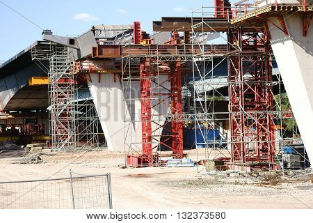 The construction of a new highway bridge with a V-shaped concrete beam.
